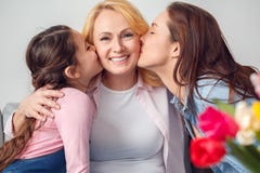Mère de grand-mère et de fille fille et petite-fille s'asseyantes de célébration ensemble à la maison embrassant mamie photographie stock Mère de grand-mère et de fille fille et petite-fille s'asseyantes de célébration ensemble à la maison embrassant mamie photographie stock