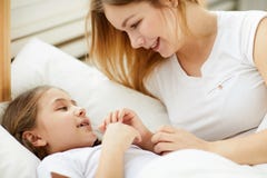 Mère de soin étendant la fille pour dormir photos libres de droits Mère de soin étendant la fille pour dormir photos libres de droits