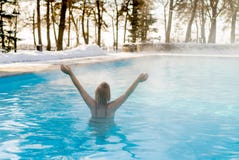 Młody blondynki kobiety dopłynięcie w outdoors basenie przy zimą zdjęcie stock Młody blondynki kobiety dopłynięcie w outdoors basenie przy zimą zdjęcie stock