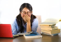 Młody cukierki i szczęśliwa Azjatycka Koreańska studencka dziewczyna w głupków szkieł działaniu rozochoconym na laptopie na biurk obraz stock Młody cukierki i szczęśliwa Azjatycka Koreańska studencka dziewczyna w głupków szkieł działaniu rozochoconym na laptopie na biurk obraz stock
