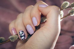 Manicure pastel color with a picture of a cute panda Royalty Free Stock Image Manicure pastel color with a picture of a cute panda Royalty Free Stock Image