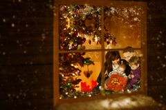 Natale finestra, famiglia che celebra festa di natale dentro la casa immagini stock Natale finestra, famiglia che celebra festa di natale dentro la casa immagini stock