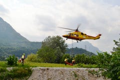 National Alpine rescue team of Lecco is exercising in rescue with the help of helicopter. stock photo National Alpine rescue team of Lecco is exercising in rescue with the help of helicopter. stock photo