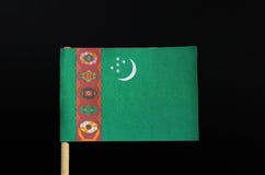 The national flag of Turkmenistan on toothpick on black background. A green field with a vertical red stripe near the hoist side royalty free stock image The national flag of Turkmenistan on toothpick on black background. A green field with a vertical red stripe near the hoist side royalty free stock image
