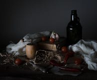 Natura morta, annata pomodori ciliegia, vecchia bottiglia con l'oleificio ed il coltello d'argento su una tavola di legno fotografia stock Natura morta, annata pomodori ciliegia, vecchia bottiglia con l'oleificio ed il coltello d'argento su una tavola di legno fotografia stock