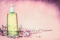 Natural cosmetic product bottle with green lotion or tonic liquid with fresh herbs and flowers at pink background. Healthy skin o Stock Photo Natural cosmetic product bottle with green lotion or tonic liquid with fresh herbs and flowers at pink background. Healthy skin o Stock Photo