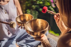 Nepal Buddha Copper Singing Bowl At Spa Salon. Young Beautiful Woman Doing Massage Therapy Singing Bowls In The Spa Royalty Free Stock Photos Nepal Buddha Copper Singing Bowl At Spa Salon. Young Beautiful Woman Doing Massage Therapy Singing Bowls In The Spa Royalty Free Stock Photos