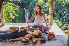 Nepal Buddha Copper Singing Bowl At Spa Salon. Young Beautiful Woman Doing Massage Therapy Singing Bowls In The Spa Royalty Free Stock Photo