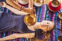 Nepal Buddha Copper Singing Bowl At Spa Salon. Young Beautiful Woman Doing Massage Therapy Singing Bowls In The Spa Royalty Free Stock Image