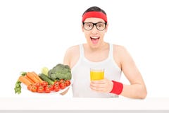 Nerdy young guy holding a glass of orange juice royalty free stock photo Nerdy young guy holding a glass of orange juice royalty free stock photo