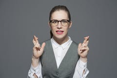 A nervous businesswoman with crossed fingers royalty free stock image A nervous businesswoman with crossed fingers royalty free stock image