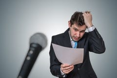 Nervous man is afraid of public speech and sweating. Microphone in front royalty free stock photo Nervous man is afraid of public speech and sweating. Microphone in front royalty free stock photo