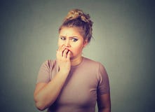 Nervous stressed young woman student biting fingernails looking anxiously craving royalty free stock photo Nervous stressed young woman student biting fingernails looking anxiously craving royalty free stock photo
