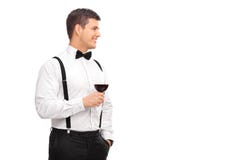 Netter junger Mann, der ein Glas Rotwein hält Stockfotografie Netter junger Mann, der ein Glas Rotwein hält Stockfotografie