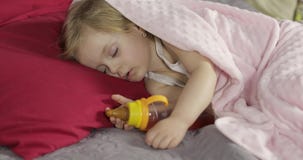 Nettes Baby, das zu Hause auf dem Bett schl?ft Wenig M?dchen, das im Morgenlicht schl?ft stock footage Nettes Baby, das zu Hause auf dem Bett schl?ft Wenig M?dchen, das im Morgenlicht schl?ft stock footage