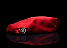 New Car Hidden Under Red Cover Royalty Free Stock Image New Car Hidden Under Red Cover Royalty Free Stock Image