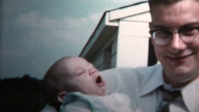 1958 - New Dad Holding Baby Versus Grandpa Holding Baby