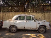 New Delhi, India - April 25, 2019. A Old White Ambassador car is parked on a street stock image New Delhi, India - April 25, 2019. A Old White Ambassador car is parked on a street stock image