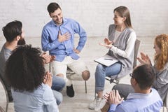 Happy people clapping at support group meeting stock images Happy people clapping at support group meeting stock images