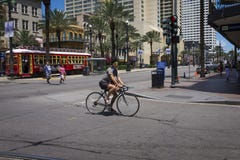 Street scene at Canal Street with a man on a bicycle in the downtown of the city of New Orleans, Louisiana royalty free stock images Street scene at Canal Street with a man on a bicycle in the downtown of the city of New Orleans, Louisiana royalty free stock images