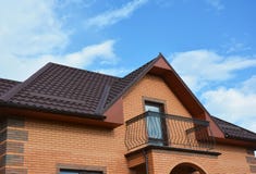 New Roofing Construction With Attic Balcony, Rain Gutter System, Roof Windows And Roof Protection From Snow Board, Snow Guard Royalty Free Stock Photography New Roofing Construction With Attic Balcony, Rain Gutter System, Roof Windows And Roof Protection From Snow Board, Snow Guard Royalty Free Stock Photography