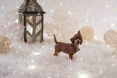 New Year card with toy dog in a fairy forest on winter background with snow and lights. royalty free stock photography New Year card with toy dog in a fairy forest on winter background with snow and lights. royalty free stock photography