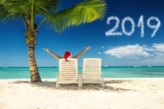 New year 2019 and woman in santa`s hat on tropical beach stock photo New year 2019 and woman in santa`s hat on tropical beach stock photo