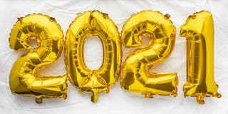 2021 new year numbers in golden foil balloons on white sheet background