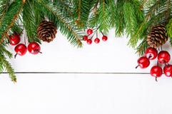 New Year`s, Christmas Theme. Green Fir Branches, Decorative Berries On White Wooden Background. Stock Photo