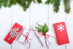 New Year`s, Christmas theme. Green fir branches, gift boxes on white wooden background Royalty Free Stock Photo New Year`s, Christmas theme. Green fir branches, gift boxes on white wooden background Royalty Free Stock Photo