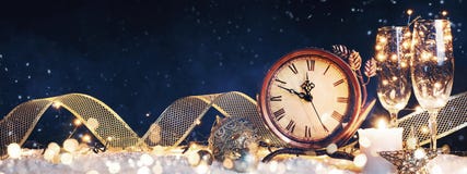New Year`s clock with christmas decorations on snow stock image New Year`s clock with christmas decorations on snow stock image