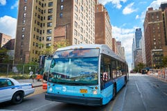 NEW YORK CITY, MANHATTAN, OCT. 25, 2013: View on NYC bus and cars on the road with different buildings, skyscrapers in the backgro stock image NEW YORK CITY, MANHATTAN, OCT. 25, 2013: View on NYC bus and cars on the road with different buildings, skyscrapers in the backgro stock image