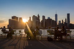 NEW YORK, USA - AUGUST 25, 2014: People resting at sunset in Br stock photo NEW YORK, USA - AUGUST 25, 2014: People resting at sunset in Br stock photo