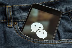 Black phone with logo of social media WeChat from China on the screen. royalty free stock photography Black phone with logo of social media WeChat from China on the screen. royalty free stock photography
