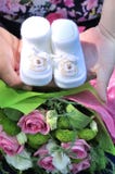 Newborn baby booties in parents hands. royalty free stock photo Newborn baby booties in parents hands. royalty free stock photo