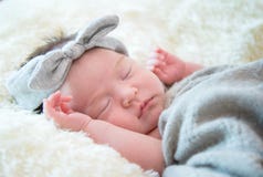 Newborn baby girl is sleeping on fur blanket stock photos Newborn baby girl is sleeping on fur blanket stock photos