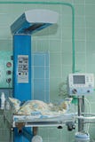 Newborn baby on infant warmer in neonatal intensive care unit royalty free stock images Newborn baby on infant warmer in neonatal intensive care unit royalty free stock images