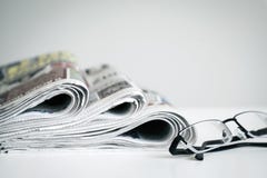 Newspapers with eyeglasses on white background royalty free stock photos Newspapers with eyeglasses on white background royalty free stock photos