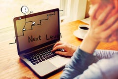 Next level concept with man using a laptop stock photo Next level concept with man using a laptop stock photo