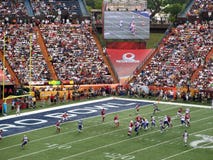NFC Quarterback Drew Brees throws ball towards end zone with other All-star Players in motion during play and ball seen flying in royalty free stock images NFC Quarterback Drew Brees throws ball towards end zone with other All-star Players in motion during play and ball seen flying in royalty free stock images