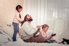 Nice caring father doing a hairstyle for his daughter royalty free stock images Nice caring father doing a hairstyle for his daughter royalty free stock images