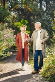 Nice pleasant aged woman giving her hand to the husband stock photo Nice pleasant aged woman giving her hand to the husband stock photo