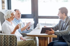 NIce Smiling Aged Couple Having Meeting In The Cafe Royalty Free Stock Photos