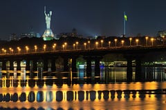 Night Cityscape Panorama Of Illuminated Paton Bridge Over Dnieper River. Famous Motherland Monument At The Background Stock Images