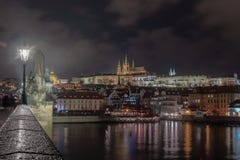 Night image of Prague castle from Charles bridge with river in the foreground royalty free stock photos Night image of Prague castle from Charles bridge with river in the foreground royalty free stock photos