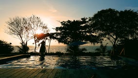 Night-time by a backyard pool facing the ocean royalty free stock image Night-time by a backyard pool facing the ocean royalty free stock image