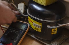 Nikolaev, Ukraine - June 30, 2020: An Electrician With A Multimeter Checks The Electrical Resistance Of The Refrigerator Stock Photos Nikolaev, Ukraine - June 30, 2020: An Electrician With A Multimeter Checks The Electrical Resistance Of The Refrigerator Stock Photos