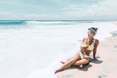 Noix de coco potable de femme sur la plage tropicale images libres de droits Noix de coco potable de femme sur la plage tropicale images libres de droits