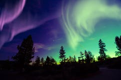 Northern lights aurora borealis in the night sky over beautiful lake landscape royalty free stock photos Northern lights aurora borealis in the night sky over beautiful lake landscape royalty free stock photos