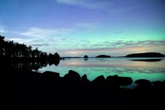 Northern lights dancing over calm lake aurora borealis Royalty Free Stock Images Northern lights dancing over calm lake aurora borealis Royalty Free Stock Images